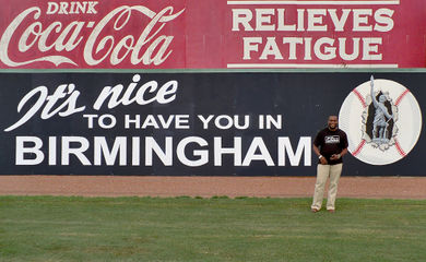André Natta posing with the sign at Rickwood Field after the 2010 Rickwood Classic