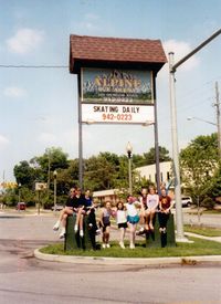 Group of figure skaters underneath the sign on the last day of operation, May 31, 2000.